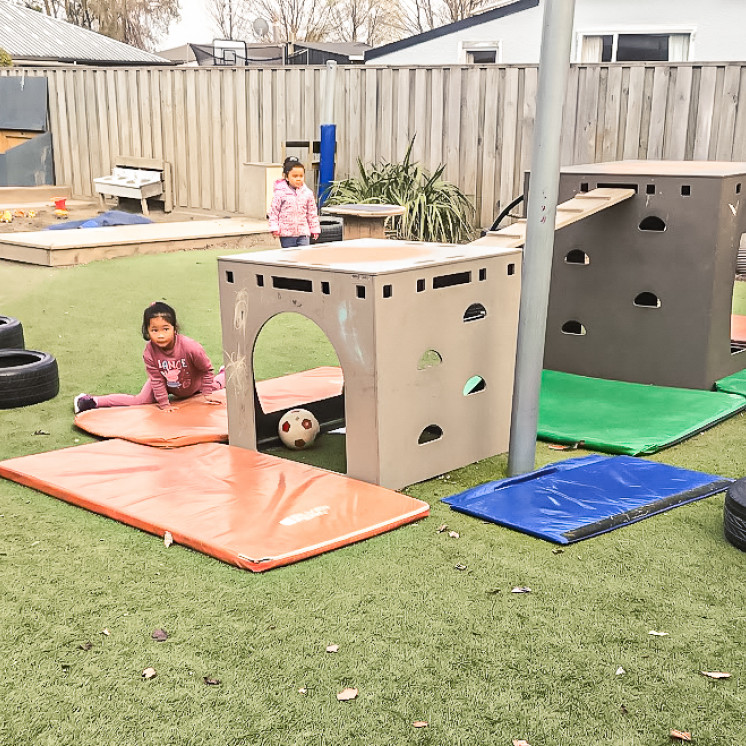 Kids playing outside on playground at Busy Bees Ashburton