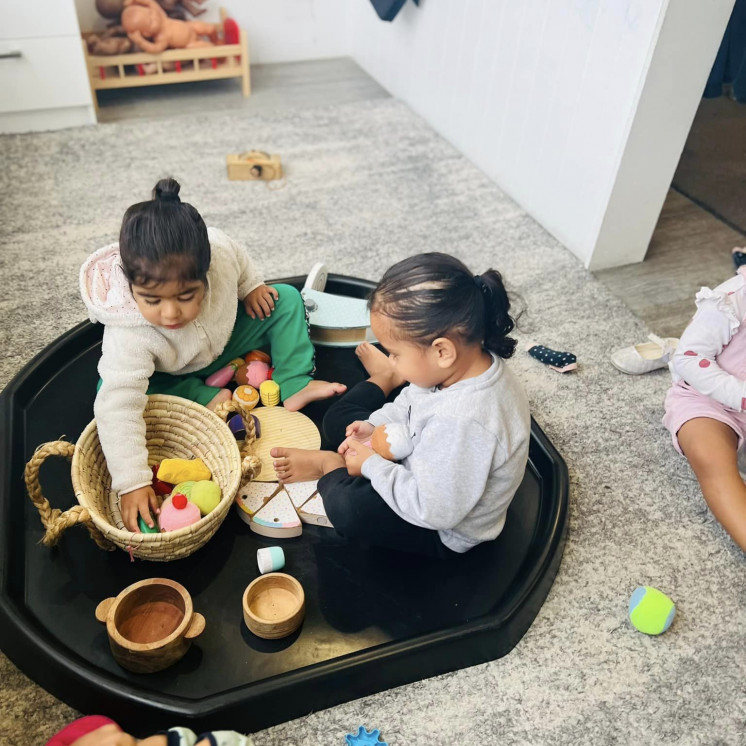 Busy Bees Alfriston Road friends enjoying playing together with food items