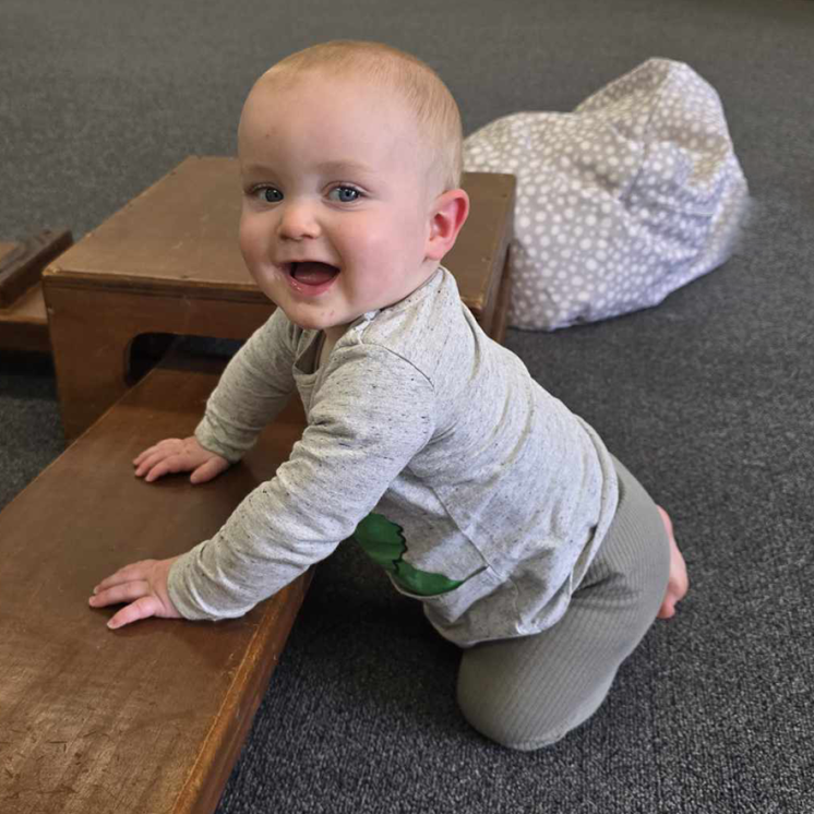 Baby having fun indoors at Busy Bees Aoraki