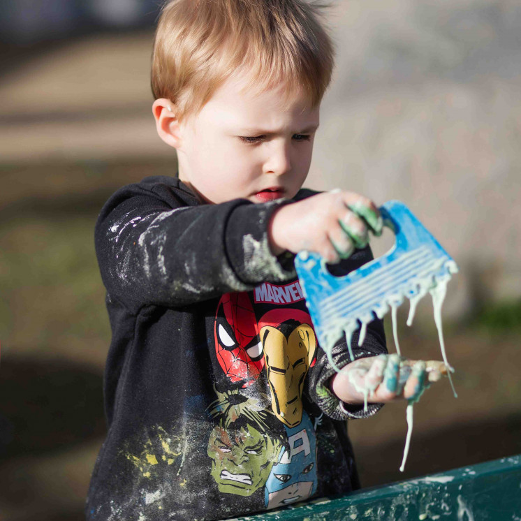 Little boy enjoying sensory play at early childhood centre in Palmerston North at Busy Bees on Church Street