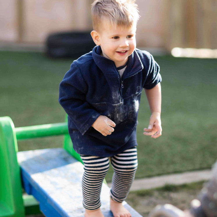 Little boy playing outside at Busy Bees Church Street early childhood learning centre