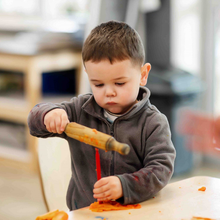 Little boy playing inside early childhood centre in Palmerston North at Busy Bees on Church Street