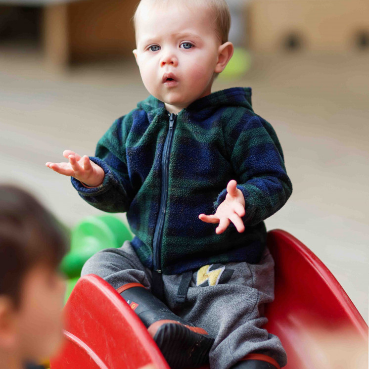 Little boy climbing at the playground of early childhood centre in Palmerston North at Busy Bees on Church Street