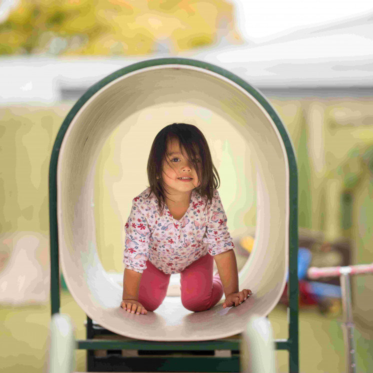 Child in tunnel of playground at Busy Bees Douglas Street