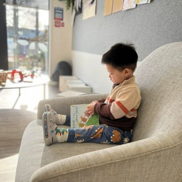 Busy Bees Hobsonville Kid reading a book