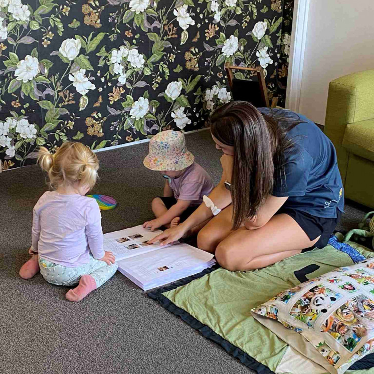 Quiet time in the nursery at Busy Bees Mapua enjoying looking over child portfolios