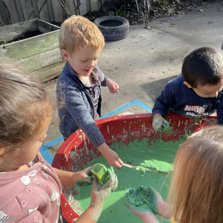 Toddlers experiencing different materials at Busy Bees Masterton