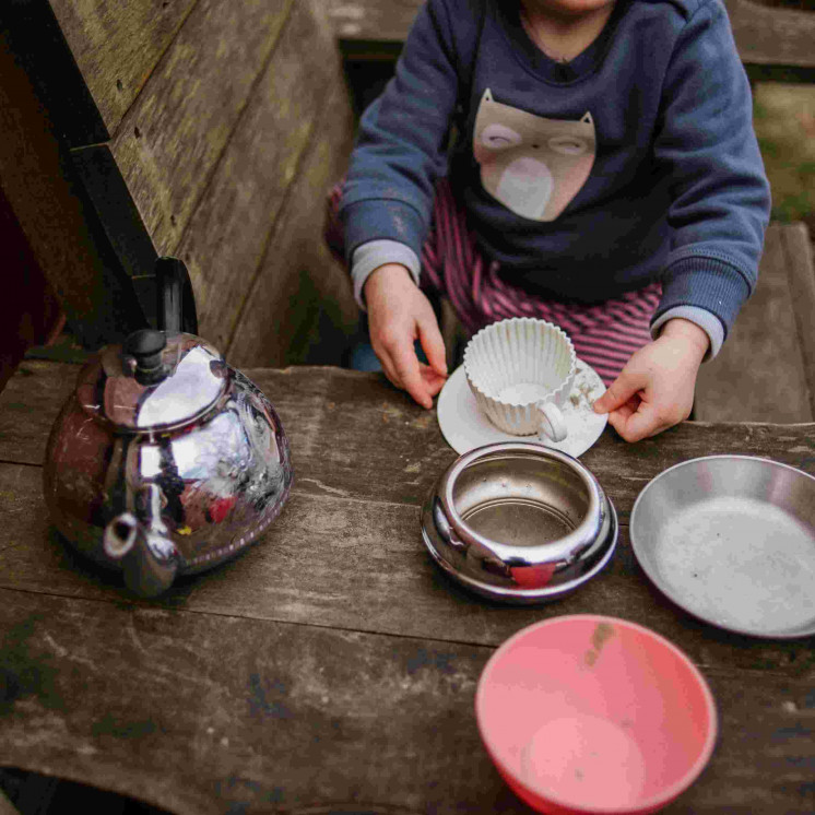 Girl setting up tea party in the sandpit at Busy Bees Motueka Childcare