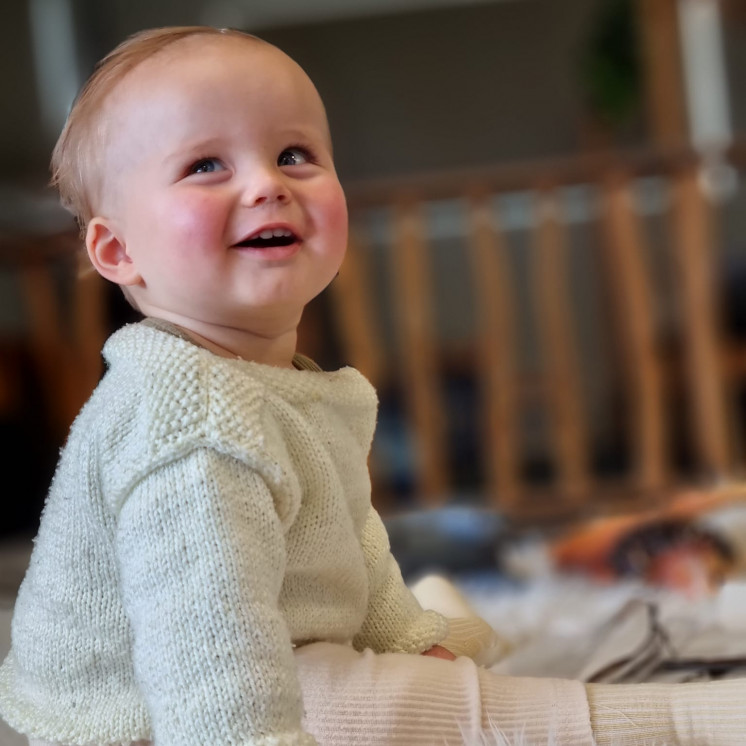 Bright, happy baby at Busy Bees Napier Road nursery