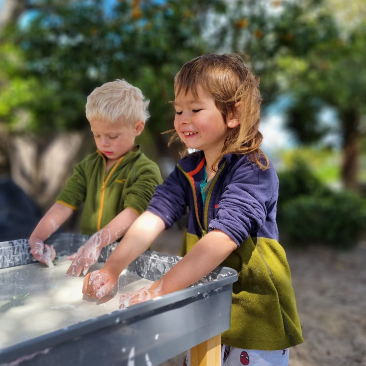 Boys immersed in messy play at Busy Bees Napier Road