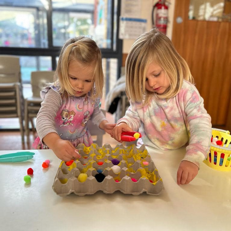 Busy Bees Pakuranga Girls working together to complete puzzle