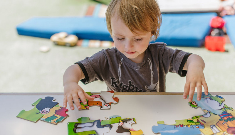 Busy Bees Richmond boy tackling a puzzle