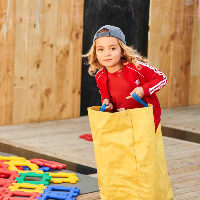 Toddler participating in a sack race at Busy Bees Roscommon Road