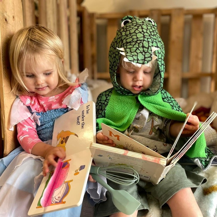 boy and girl reading books language development dress up friendss