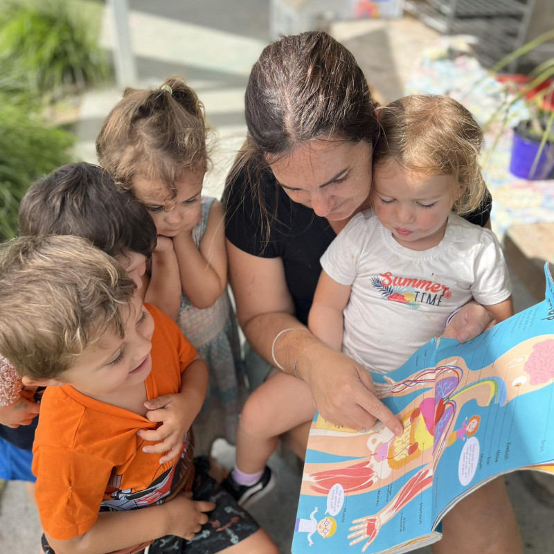 Kaiako reading books - early literacy at Busy Bees Silverdale 