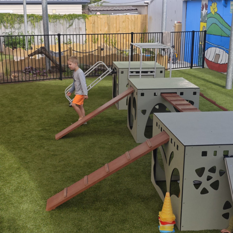 Little boy outside having fun on the playground Busy Bees Tahunanui 