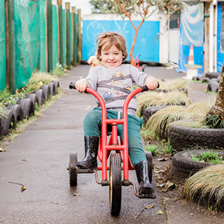 Busy Bees Waitara little boy riding bike outside