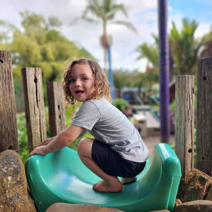Preschooler playing on outdoor playground at Busy Bees Whau Valley 