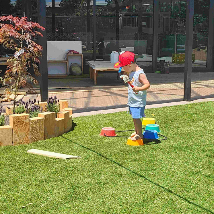 Boy balancing outside at Busy Bees Tairāwhiti childcare in Gisborne