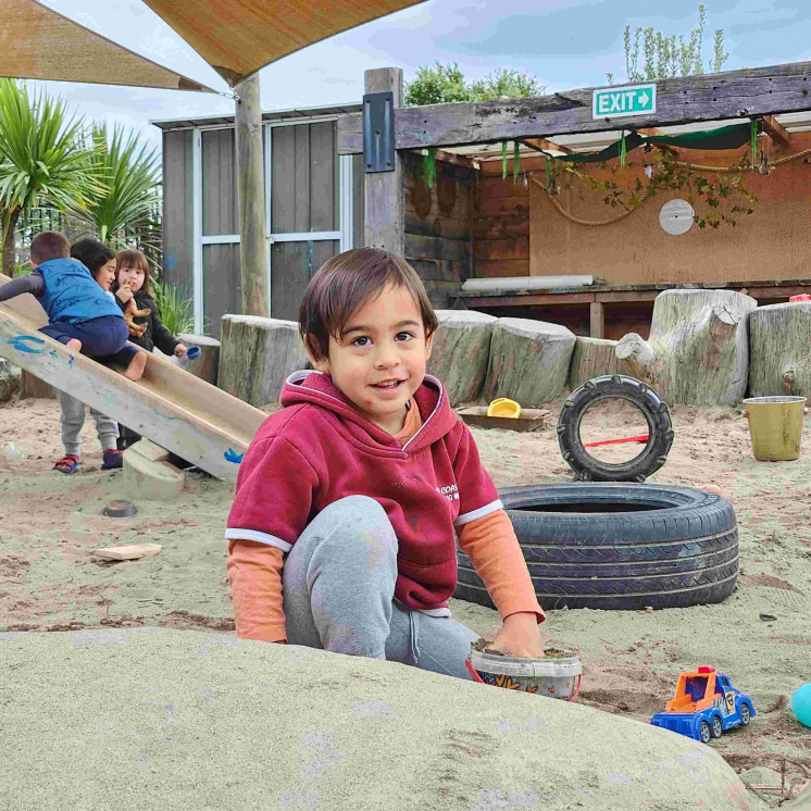 Boy building sandcastles at Busy Bees Tairāwhiti childcare in Gisborne